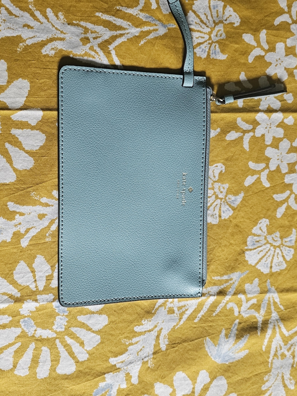 kate spade pastel blue leather wristlet pouch with gold logo